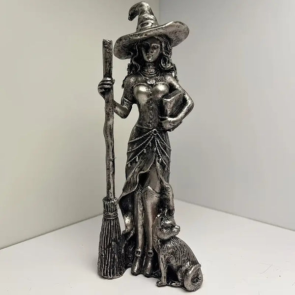 Statue of a witch holding a broom and a cat on a white background decor aura works