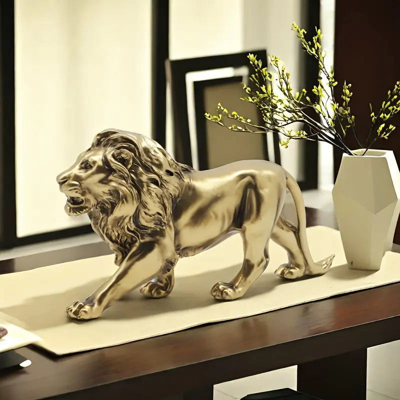 Gold lion statue on a table with a vase and branches in the background decor auraworks