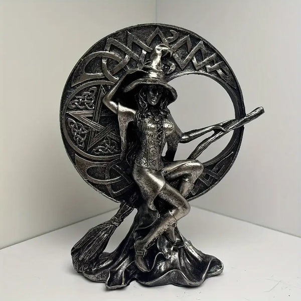 Metallic witch figurine with broomstick on a decorative circular background decor aura works