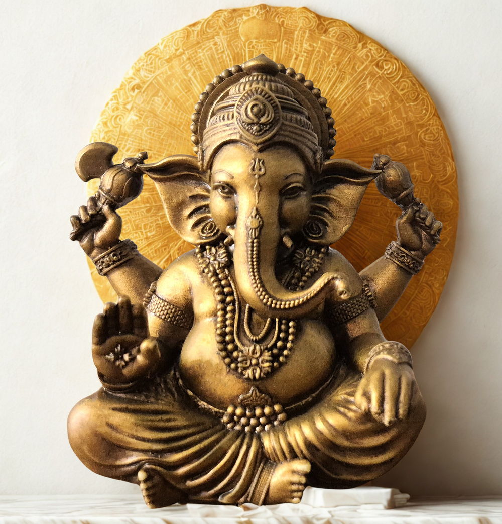 Front view of a handcrafted brass Lord Ganesha idol in a blessing pose, seated peacefully with intricate detailing, placed on a white cloth background — perfect for home decor, spirituality, and gifting. auraworks