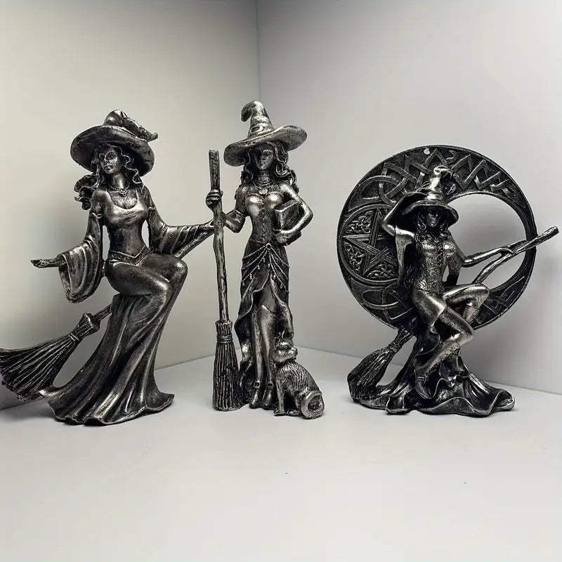 Three metallic witch figurines with brooms on a white background decor auraworks